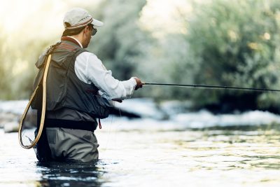 man flyfishing for trout in western north carolina river