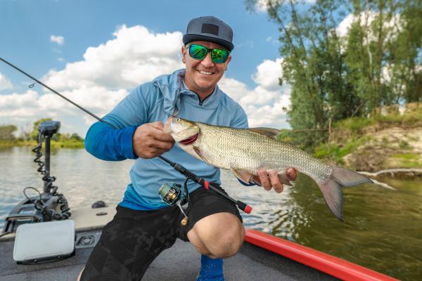 fisherman holding fish he caught in western NC